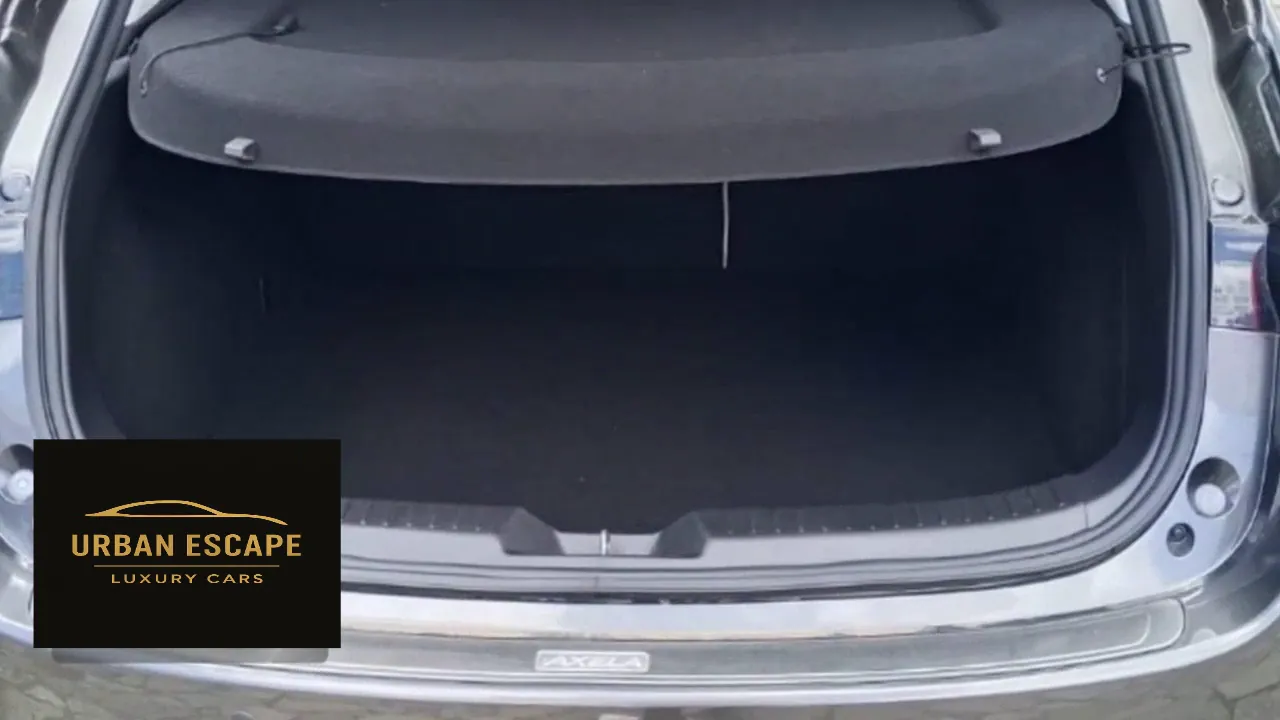 Mazda Axela boot with black carpet and parcel shelf, seen through the open tailgate