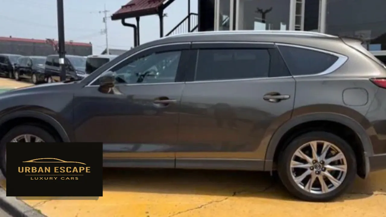 Mazda CX-8 in grey, side view of the doors, tinted windows and rear alloy wheel