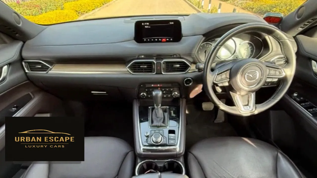 Mazda CX-8 right-hand-drive dashboard with centre screen, automatic gear lever and black leather seats