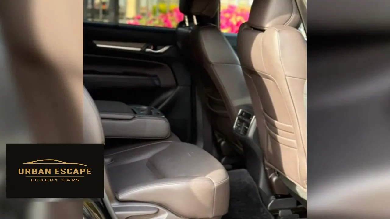 Mazda CX-8 second-row seat in brown leather with a centre armrest and rear air vents