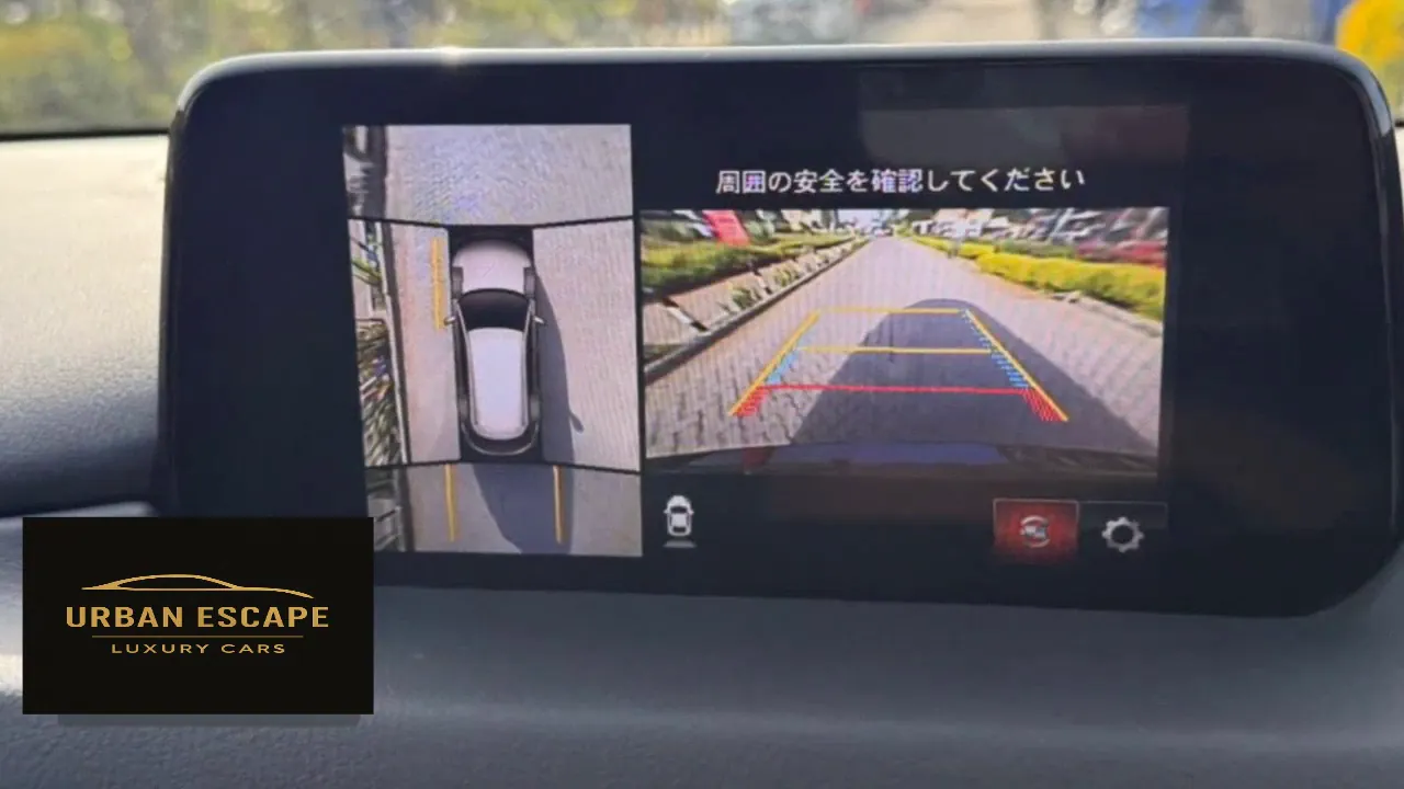 Mazda CX-8 centre screen showing a bird's-eye parking view and reversing camera with guide lines