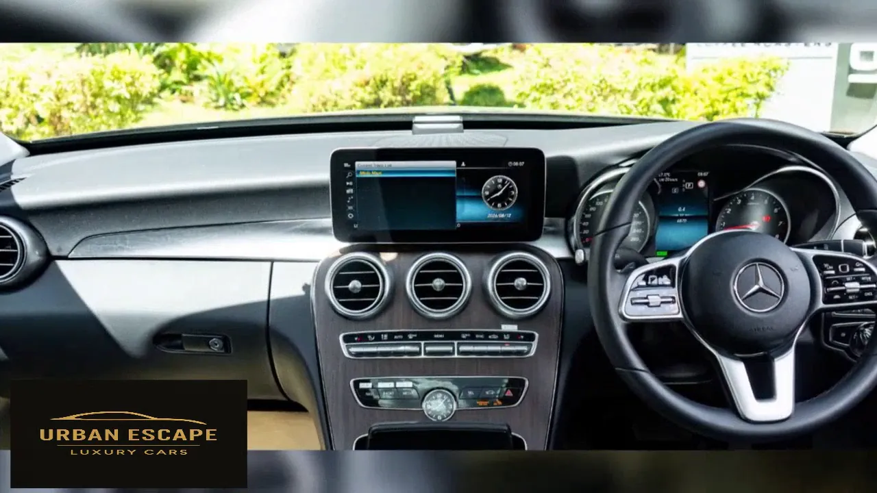 Mercedes-Benz C 200 dashboard with centre screen, three round air vents and wood-trim centre console