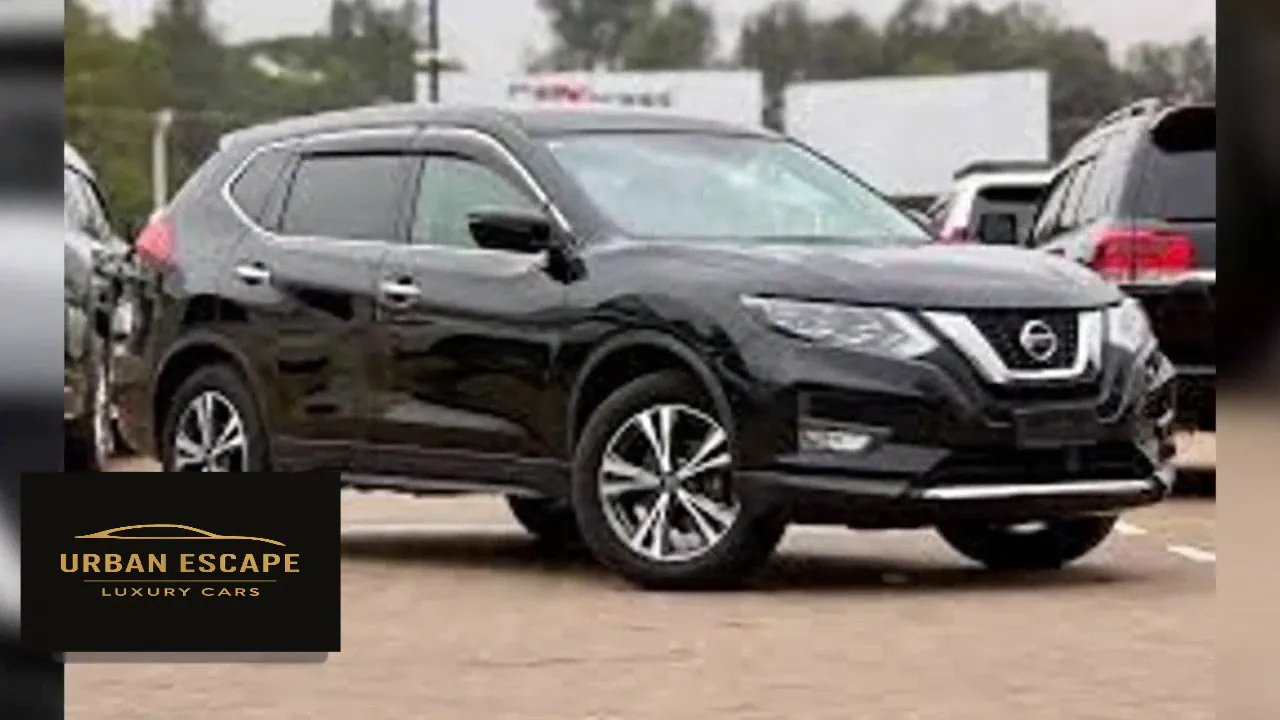 Nissan X-Trail in black, front three-quarter view with chrome V-shaped grille and alloy wheels