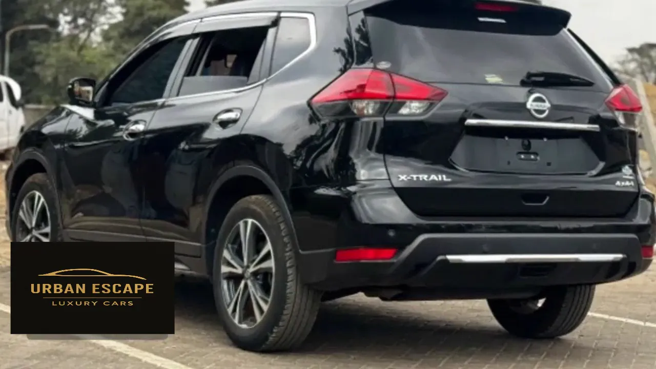 Nissan X-Trail in black, rear three-quarter view from the left, with red tail lights, chrome trim and X-Trail badge