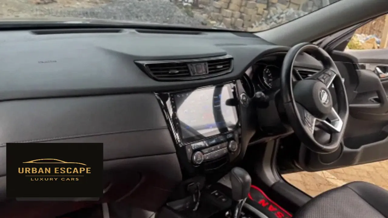Nissan X-Trail black dashboard with large touch screen, right-hand-drive steering wheel and automatic gear lever