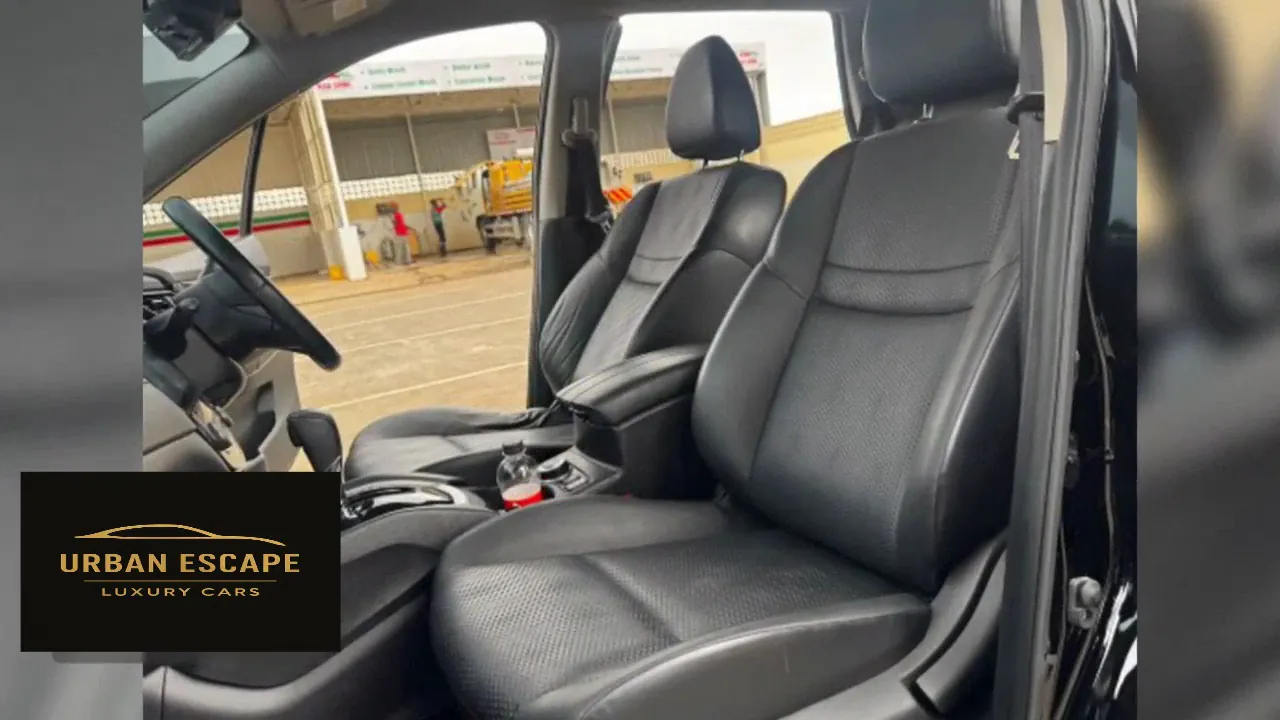 Nissan X-Trail front seats in black leather with perforated centre panels, seen through the open door