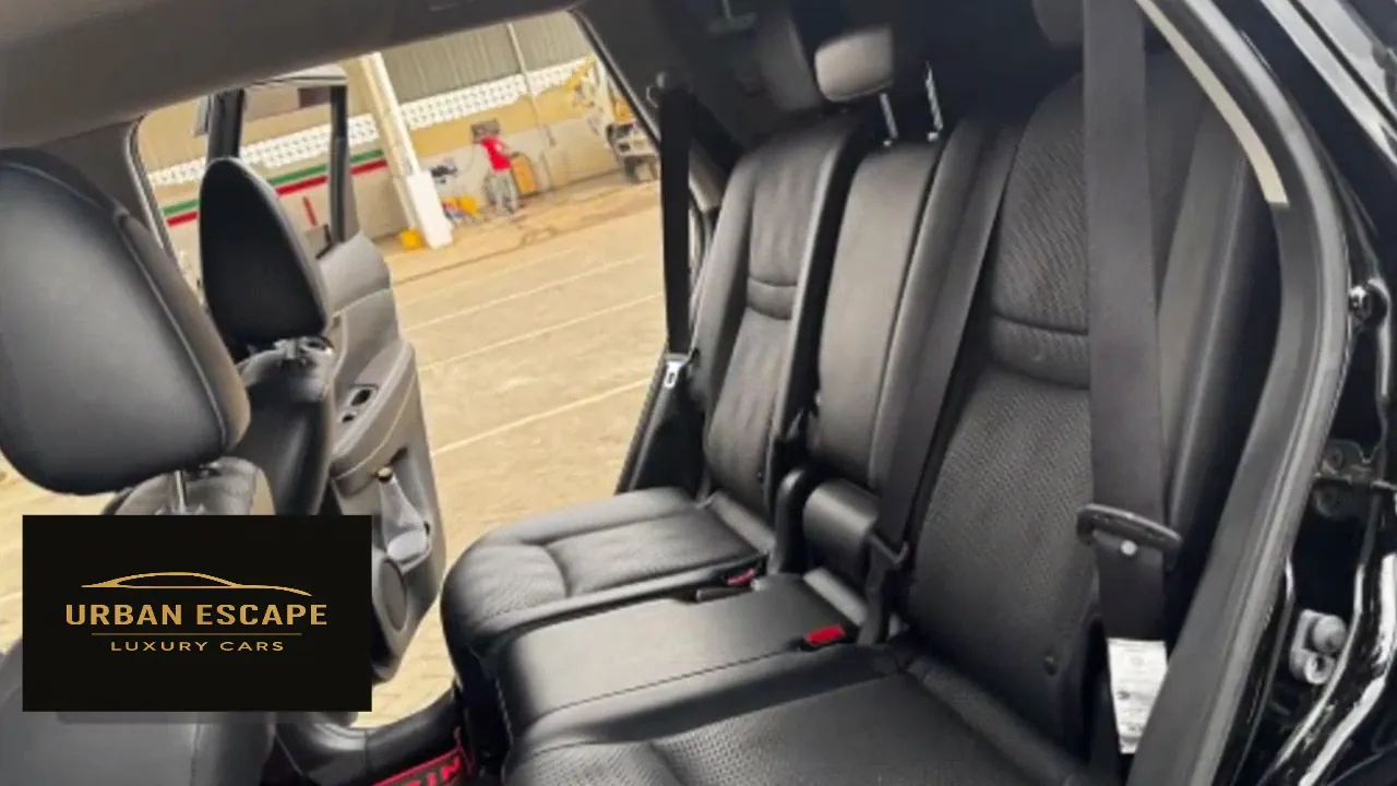 Nissan X-Trail back seats in black leather, seen through the open rear door