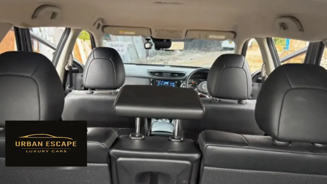 Nissan X-Trail cabin seen from the back, with black leather headrests and the dashboard ahead