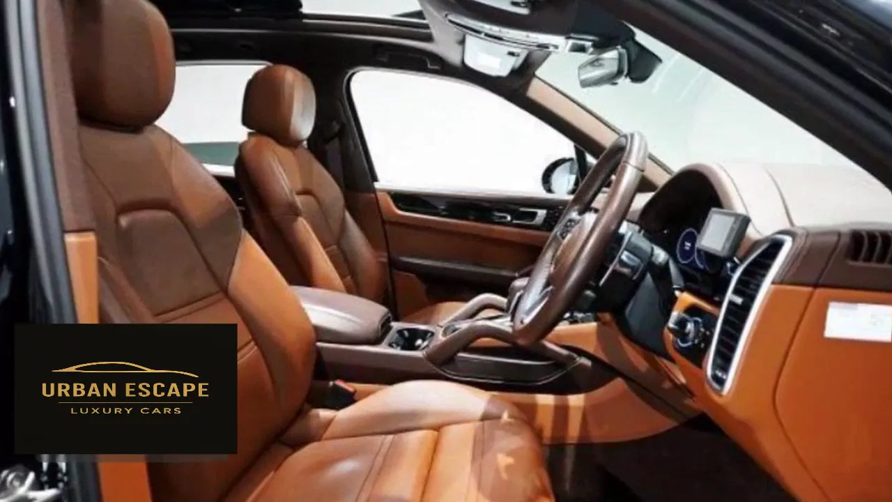 Porsche Cayenne front seats in cognac leather with matching door trim, seen through the passenger door