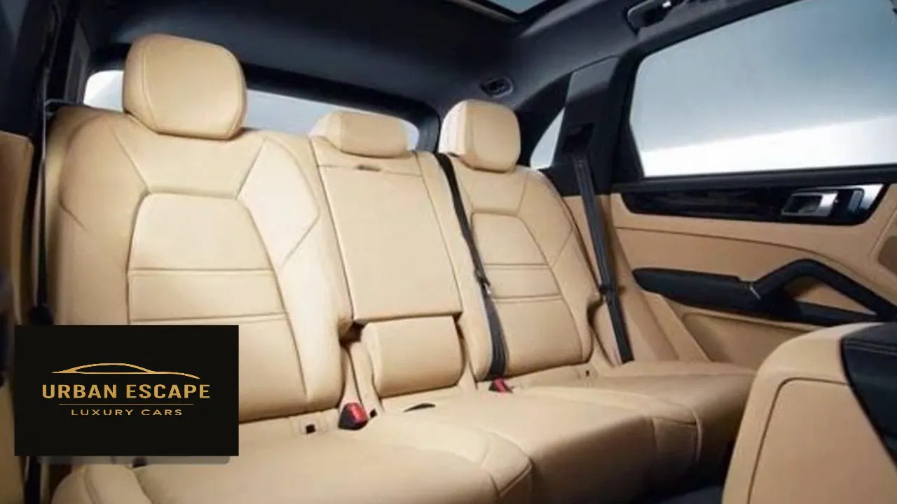 Porsche Cayenne rear bench in beige leather with three headrests, seen through the rear door