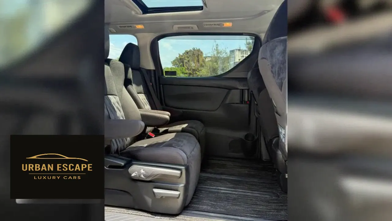 Toyota Alphard dark grey second-row seats seen from the side, showing legroom and a sunroof above