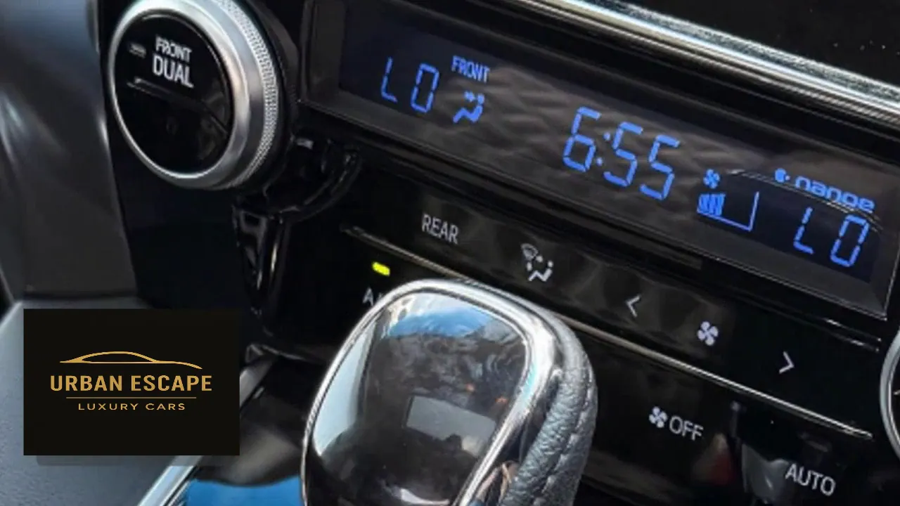 Toyota Alphard dual-zone climate control with blue digital display and chrome and leather gear knob