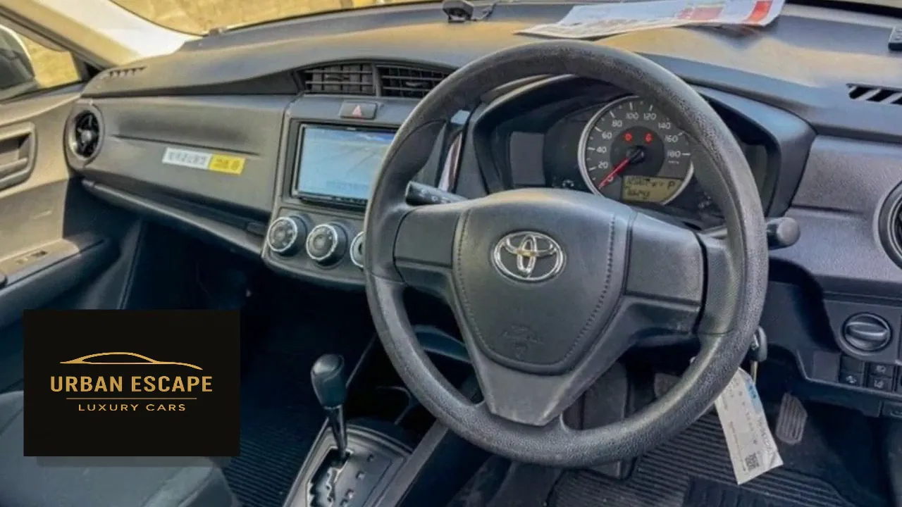 Toyota Axio right-hand-drive dashboard with steering wheel, centre screen, climate dials and automatic gear lever