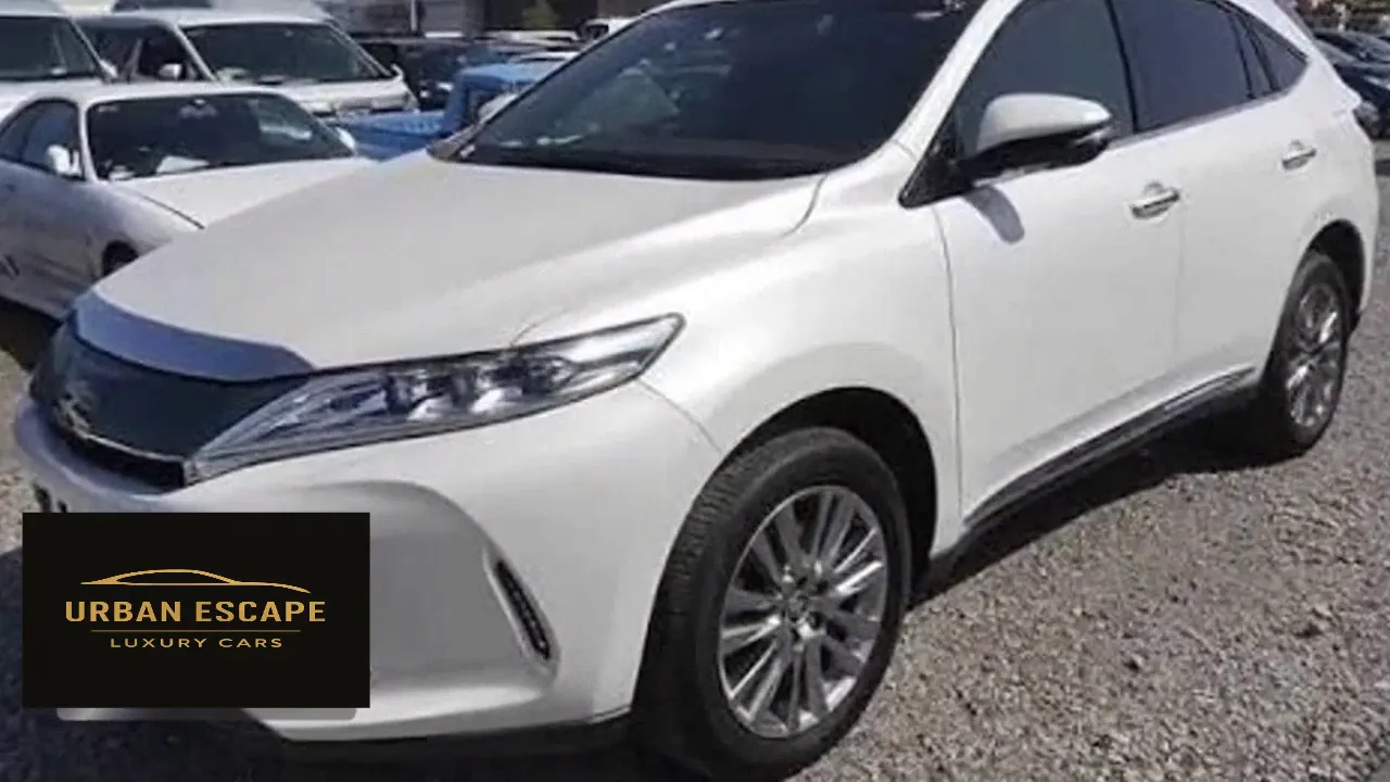 Toyota Harrier in white, front three-quarter view from the left showing the side profile and alloy wheels
