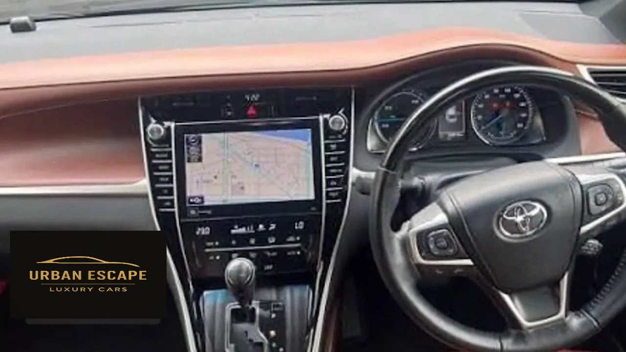 Toyota Harrier right-hand-drive dashboard with brown trim, map screen, climate controls and gear lever