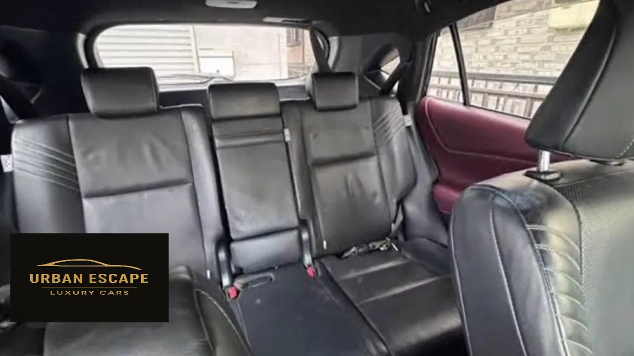 Toyota Harrier back seats in black leather with three headrests and burgundy door trim
