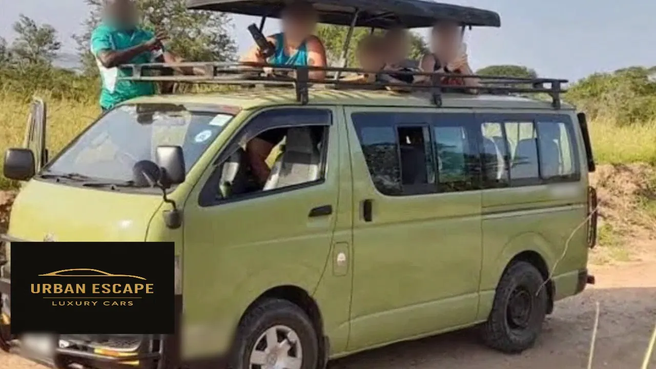 Toyota Hiace Safari Van in green, front three-quarter view with the pop-up roof raised and people in the roof hatch