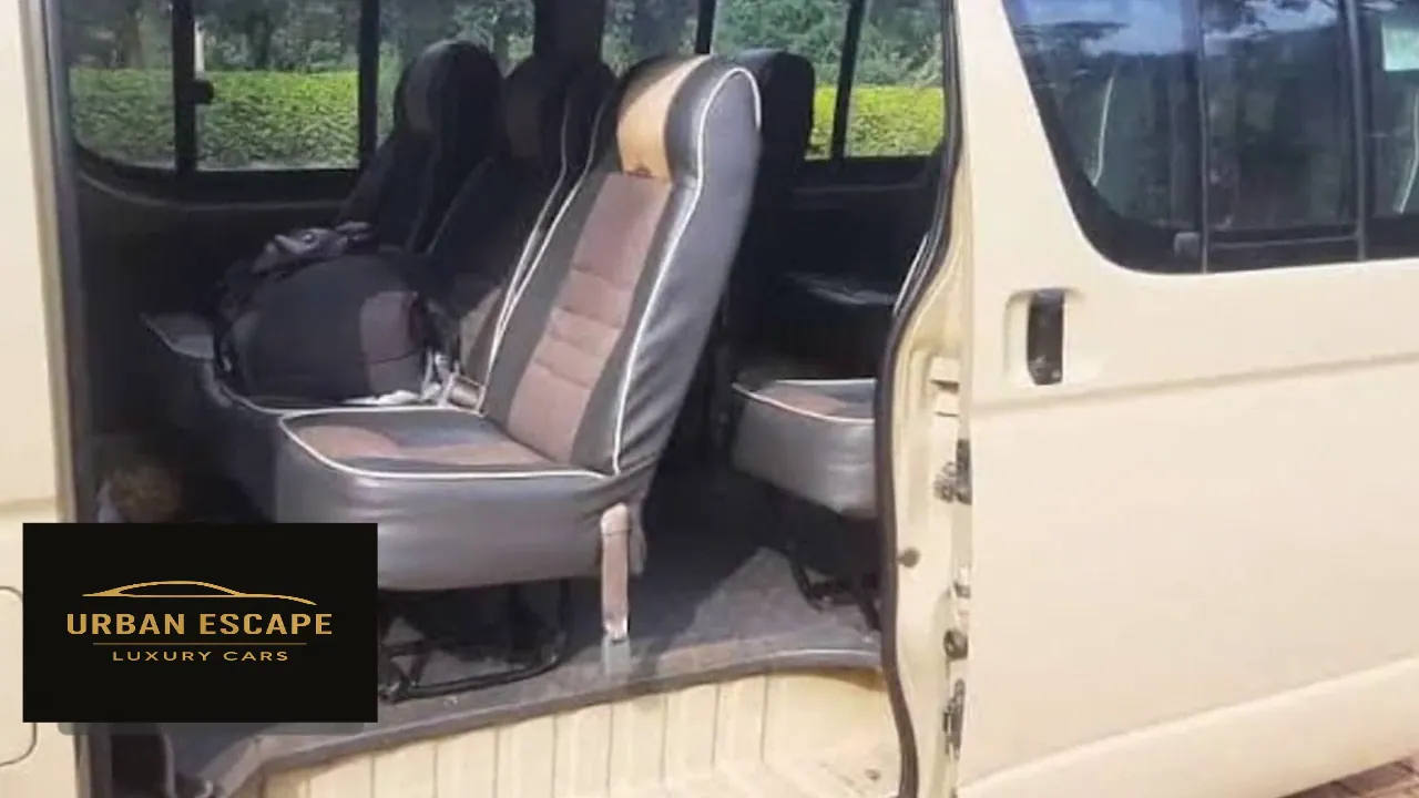 Toyota Hiace Safari Van in cream, sliding door open showing grey and brown passenger seats with white piping