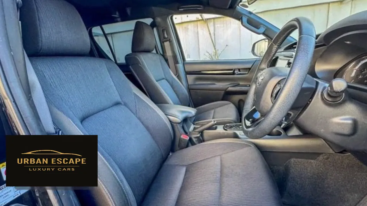 Toyota Hilux Double Cab front seats in dark grey fabric with centre armrest, right-hand drive