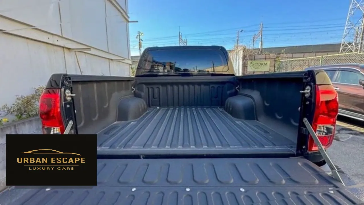 Toyota Hilux Double Cab cargo bed with ribbed black liner and the tailgate lowered