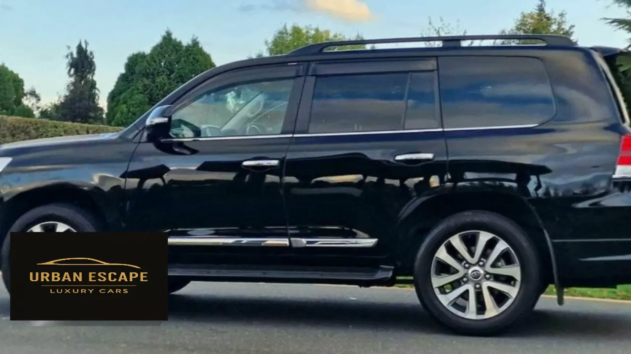 Toyota Land Cruiser V8 in black, side profile with roof rails, tinted windows and alloy wheels