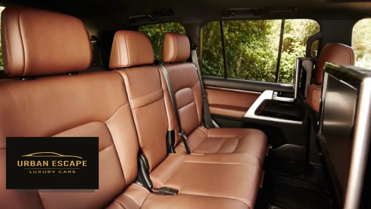 Toyota Land Cruiser V8 back seats in tan leather, with a screen on the back of the front seat