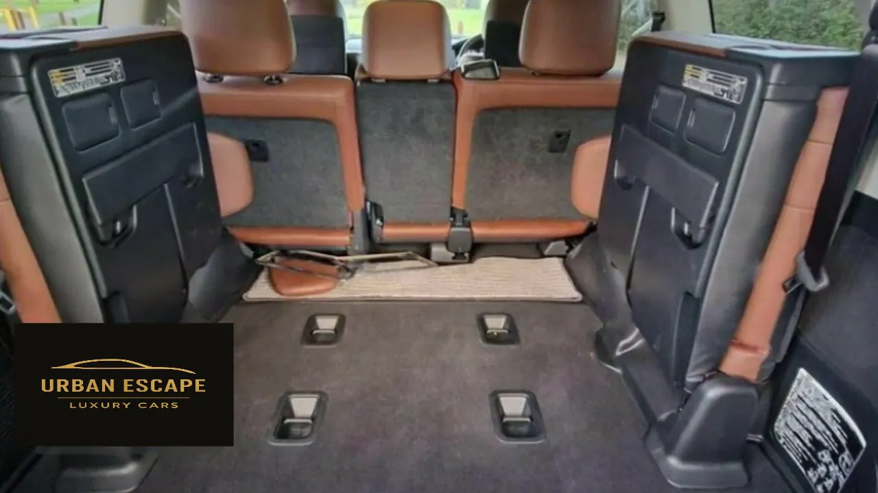 Toyota Land Cruiser V8 boot with carpeted floor and third-row seats folded up against the sides
