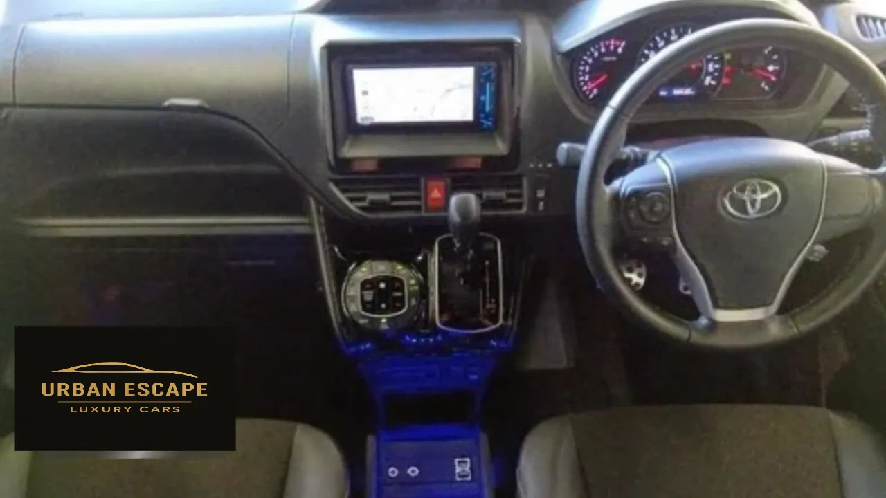 Toyota Noah dashboard with right-hand drive steering wheel, navigation screen, gear lever and blue console lights